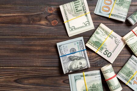 Pile of one hundred US Dollar Bills money on colored background top wiev with copy space for your...
