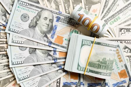 Close up of 100 dollar bills pile on background made with different dollar banknotes. Top view of financial concept.の写真素材