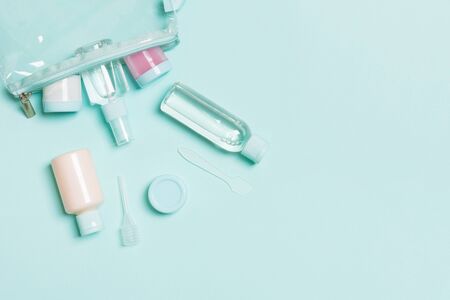 Top view of means for face care: bottles and jars of tonic, micellar cleansing water, cream, cotton...