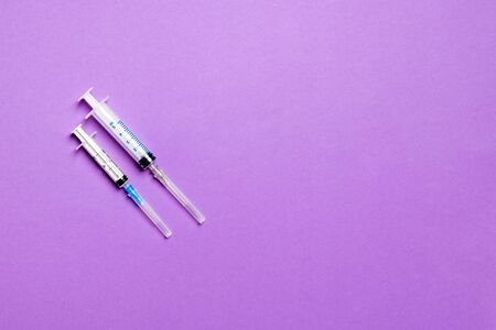 Top view of different syringes for injection on colorful background. Medical equipment concept with copy space.の写真素材