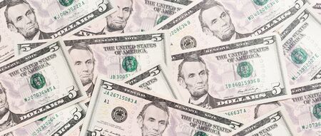 Top view of background made with 5 dollar banknotes. USD cash. American money concept.の写真素材