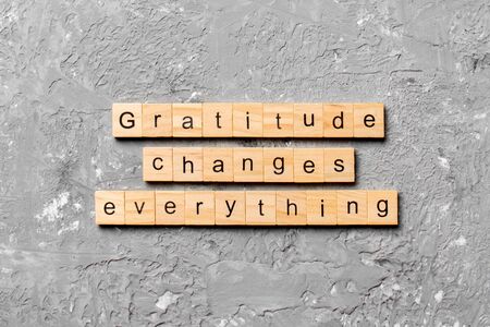 Gratitude changes everything word written on wood block. Gratitude changes everything text on cement table for your desing, concept.の写真素材