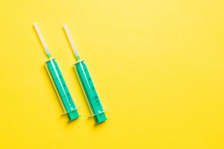 Top view of different syringes for injection on colorful background. Medical equipment concept with copy space.の写真素材