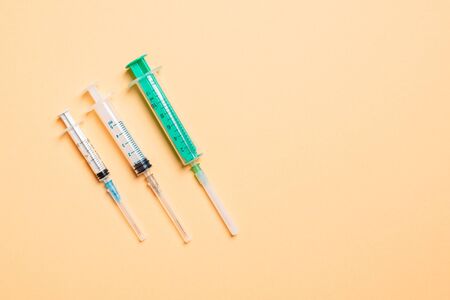 Top view of medical syringes on colorful background with copy space. Injection equipment concept.の写真素材
