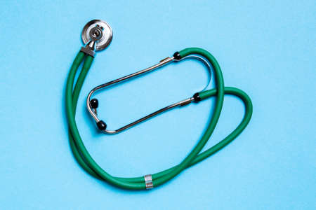 Top view of green medical stethoscope on colorful background with copy space. Medicine equipment concept.の写真素材