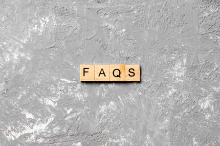 faqs word written on wood block. faqs text on table, concept.の写真素材