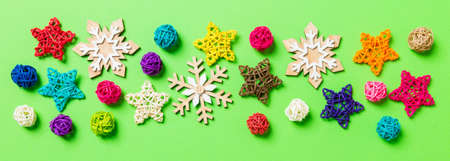 New Year decorations on green background. Festive stars and balls. Merry Christmas concept with empty space for your design Banner.の写真素材