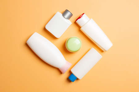 Set of White Cosmetic containers isolated on colored background, top view with copy space. Group of...