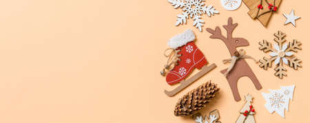 Top view of New Year toys and decorations on orange background. Christmas time concept Banner with empty space for your design.の写真素材