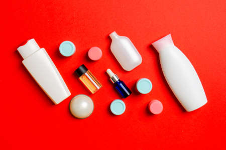 Cosmetics SPA branding mock-up, top view with copy space. set of tubes and jars of cream flat lay on colored background.の写真素材