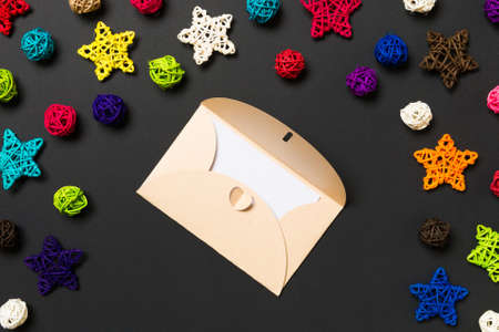 Top view of envelope on black background. New Year decorations. Christmas holiday concept.