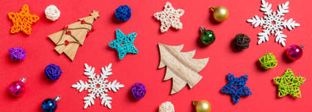 Top view Banner of holiday decorations and toys on red background. Christmas ornament concept.