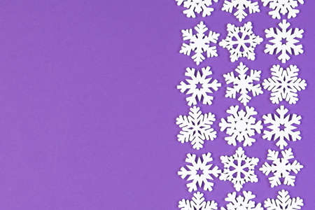 Set of white snowflakes on colorful background. Top view of Christmas ornament. New Year time...