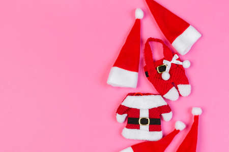 Top view red Santa hats on colorful background. Time for holiday concept with empty space for your design.の写真素材