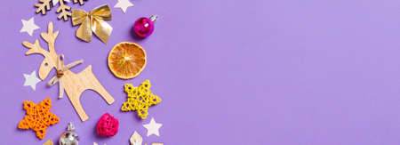 Top view Banner of New Year toys and decorations on purple background. Christmas time concept with empty space for your design.の写真素材