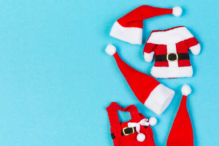 Top view Banner of red Santa hats and clothes on colorful background. Merry Christmas concept with copy space.の写真素材