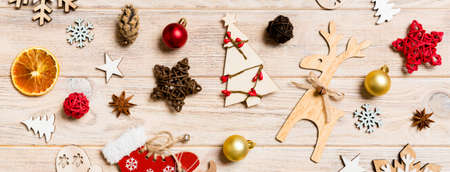 Banner top view of Christmas toys on wooden background. New Year ornament. Holiday concept.の写真素材
