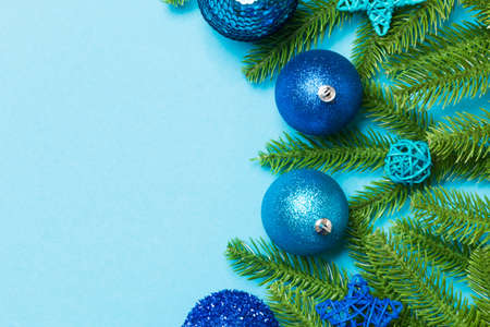 Christmas composition made of fir tree, balls and different decorations on colorful background. Top view of New Year Advent concept with empty space for your design.の写真素材