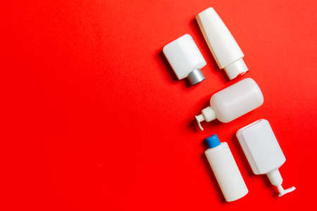 Set of White Cosmetic containers isolated on colored background, top view with copy space. Group of...