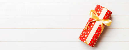 Top view of christmas or other holiday handmade present box package, flat lay white wooden...
