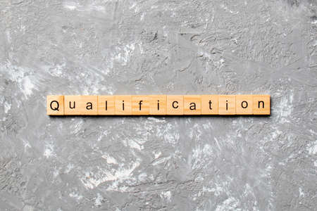 qualification word written on wood block. qualification text on table, concept.の写真素材