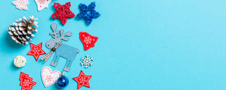 Top view Banner of New Year toys and decorations on blue background. Christmas time concept with...