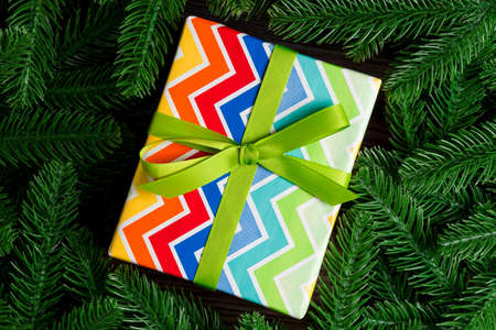 Top view of holiday gift box and fir tree branches with empty space for your design. New year...