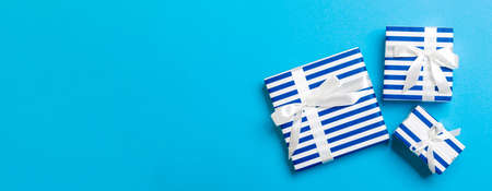 Top view Christmas present box with White bow on blue background.の写真素材
