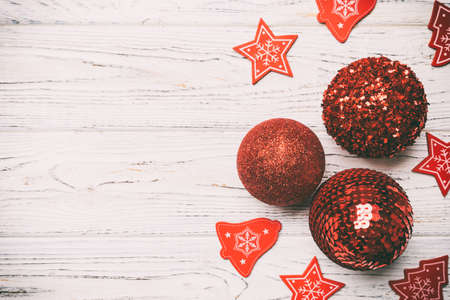Top view of Christmas balls and creative decorations on wooden background with copy space. New Year concept.の写真素材