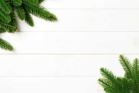 Top view of Christmas background made of fir tree branches. New year concept with copy space on wooden background.の写真素材