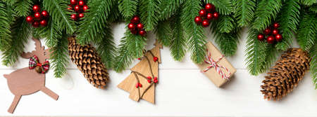 Top view of fir tree and New Year decorations on wooden background. Banner Christmas concept with...
