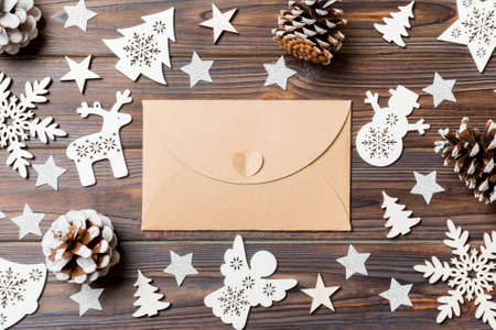 Top view of envelope on festive wooden background. Christmas toys and decorations. New Year time concept.の写真素材