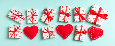 Top view of gift boxes and red textile hearts on colorful background. St Valentine's day concept with copy space.の写真素材