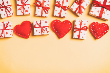 Holiday composition of gift boxes and red textile hearts on colorful background with empty space for your design. Top view of Valentine's Day concept.の写真素材
