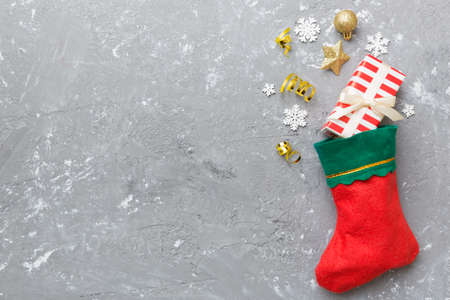 santa red sock top view on the color background with empty space. Christmas background.