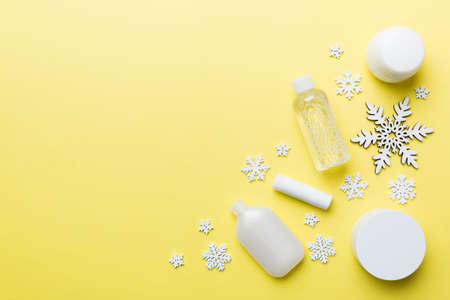 Makeup products and Christmas decorations on color background. Top view New year Beauty concept with copy space.の写真素材