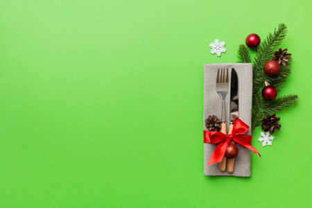Christmas table place setting with knife, napkin and fork. Holidays new year background with copy space.の写真素材