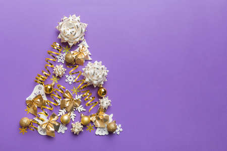 Christmas tree made from colored ball decoration on colored background, view from above. New Year minimal concept with copy space.の写真素材