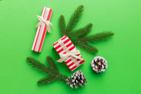 Christmas decorations and fir tree branch and gift boxon dark table. Top view frame with copy space.