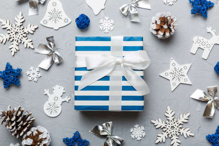 Christmas composition. Gifts box with new year decorations on colored background. Christmas, winter, new year concept. Flat lay, top view, copy space.の写真素材