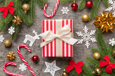 Christmas composition. Gifts box with new year decorations on colored background. Christmas, winter, new year concept. Flat lay, top view, copy space.の写真素材