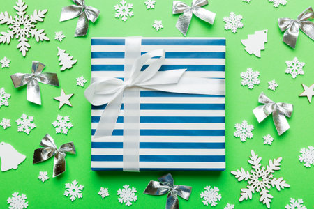 Christmas composition. Gifts box with new year decorations on colored background. Christmas, winter, new year concept. Flat lay, top view, copy space.の写真素材
