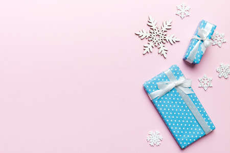Holiday flat lay with gift boxes wrapped in colorful paper and tied decorated with confetti on...