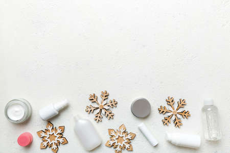 Makeup products and Christmas decorations on color background. Top view New year Beauty concept with copy space.の写真素材