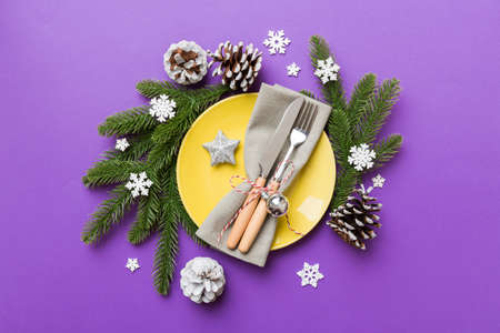 Christmas table place setting with christmas decor and plates, kine, fork and spoon. Christmas holiday background. Top view with copy space.の写真素材