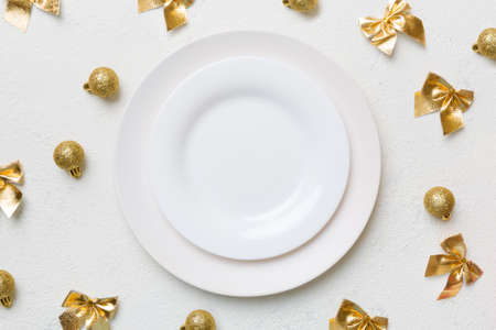 Christmas wooden background with fir branches, decoration and white plate