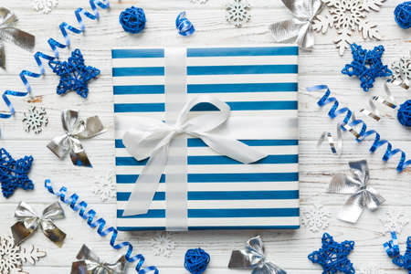Christmas composition. Gifts box with new year decorations on colored background. Christmas, winter, new year concept. Flat lay, top view, copy space.の写真素材