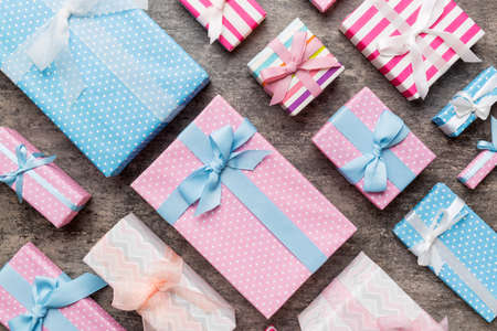 A lot of Christmas gift boxes in colored paper decorated on table, Top view close up. Many present New Year gift.の写真素材