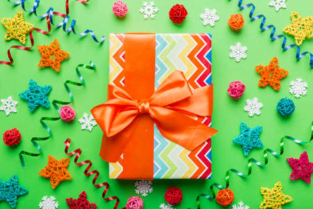 Christmas composition. Gifts box with new year decorations on colored background. Christmas, winter,...