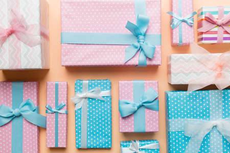 A lot of Christmas gift boxes in colored paper decorated on table, Top view close up. Many present New Year gift.の写真素材
